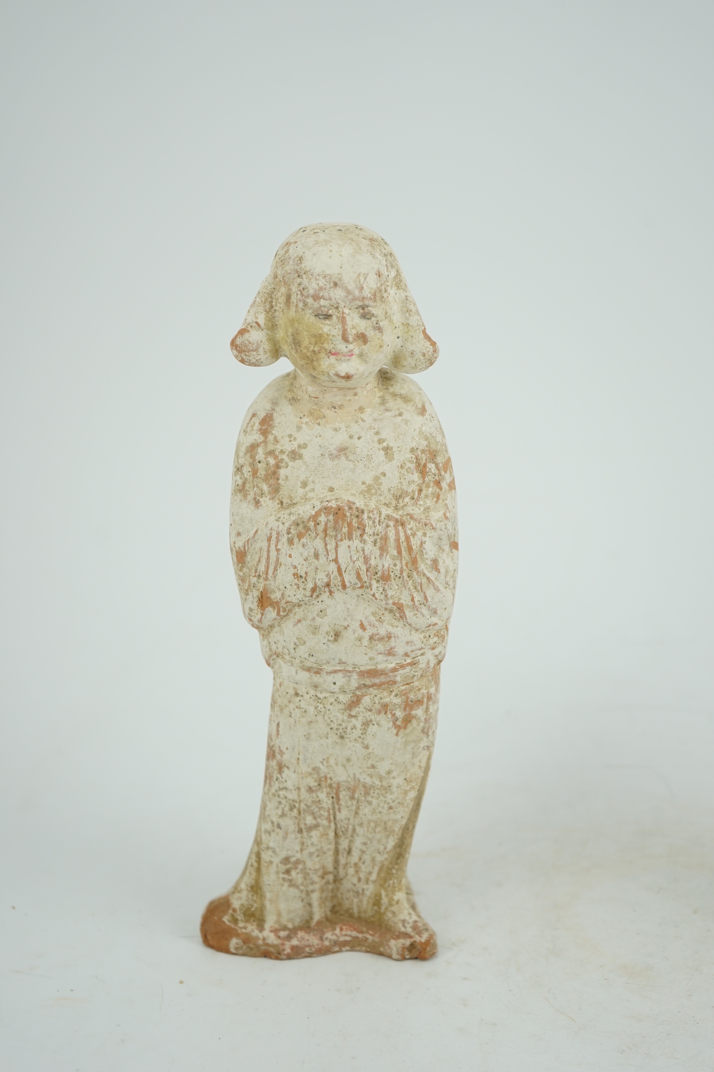 A Chinese painted pottery groom figure, Tang Dynasty (AD 618-906)